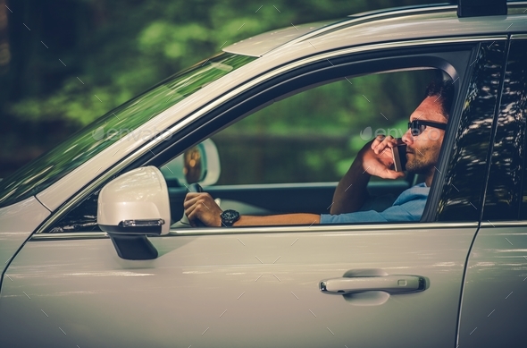 Driving with the Cell Phone - Stock Photo - Images