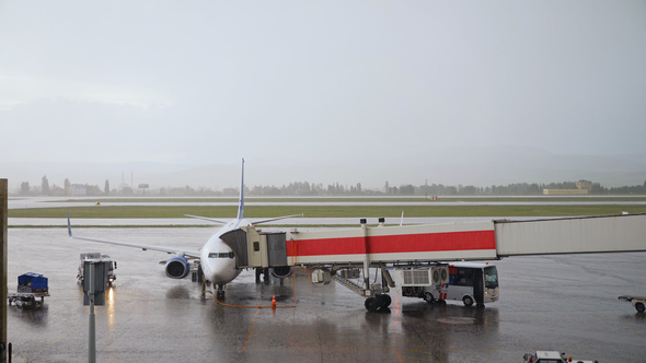 Plane At The Airport In The Rain