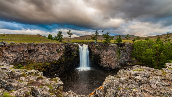 Sunset Over Waterfall Ulaan Tsutgalan, Mongolia alt