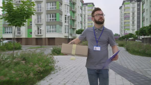 Young Bearded Man Searching Client Address To Deliver Box alt