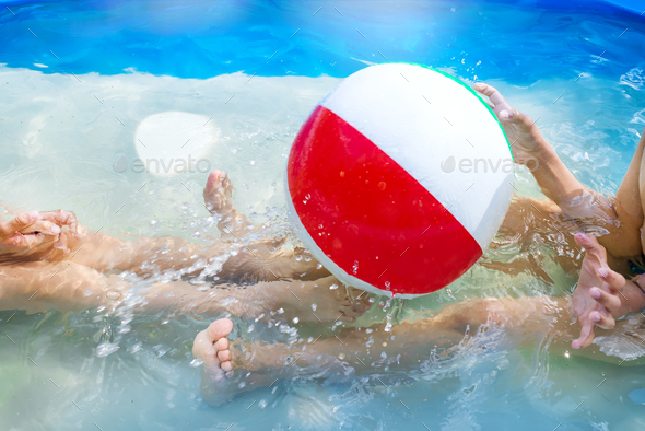 Kids playing at outdoor swimming pool. Little girl and boy play and swim in a home inflated pool - Stock Photo - Images