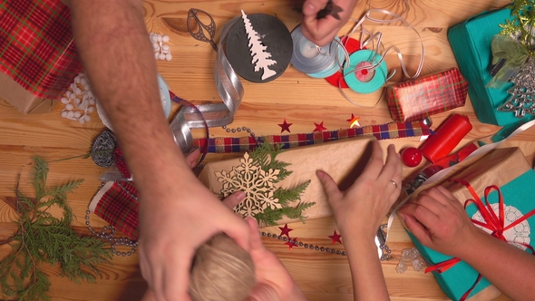 Hands of Packaged Gifts for Christmas alt