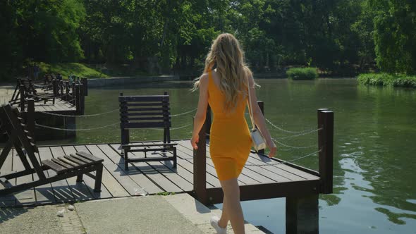 Woman walking on a wooden dock alt