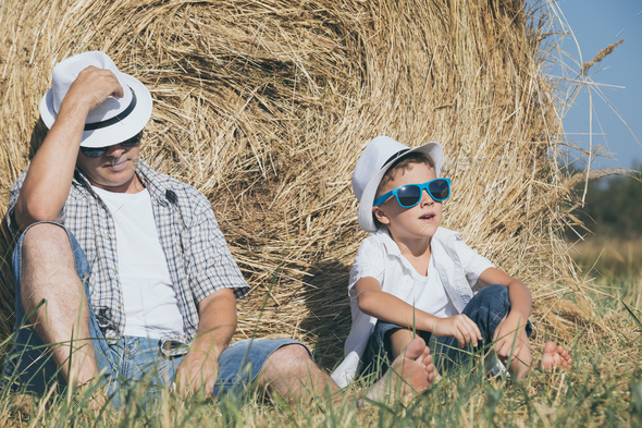 Father and son sitting in the park at the day time. - Stock Photo - Images