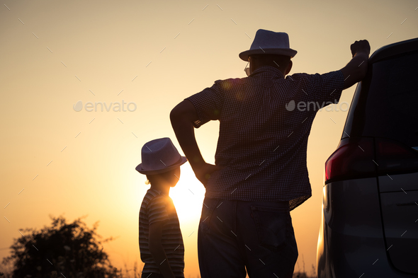 Father and son playing in the park at the sunset time. - Stock Photo - Images