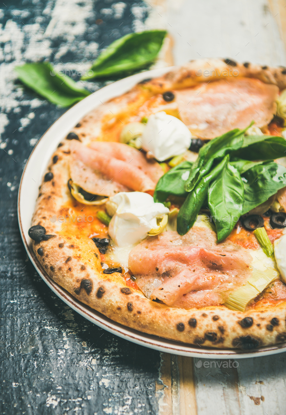 Freshly baked pizza with ham, artichokes and cream cheese, close-up Stock Photo by sonyakamoz