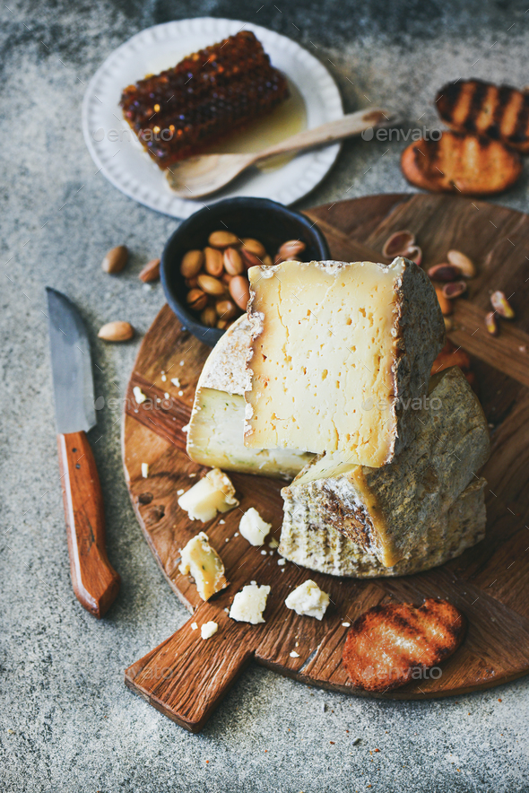 Cheese platter with cheese assortment, nuts, honey and bread - Stock Photo - Images