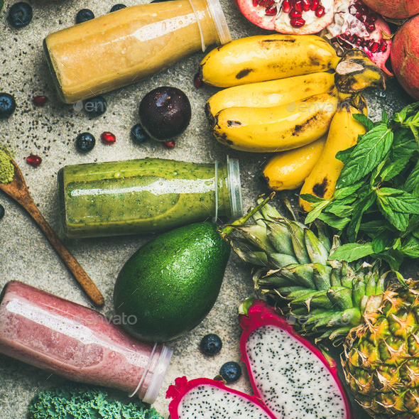 Colorful smoothies in bottles with fresh tropical fruit, square crop - Stock Photo - Images