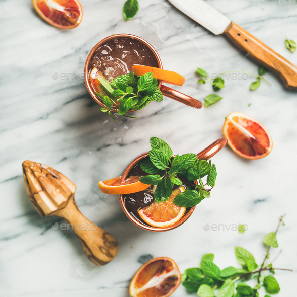 Blood orange Moscow mule alcohol cocktails, marble background, square crop - Stock Photo - Images