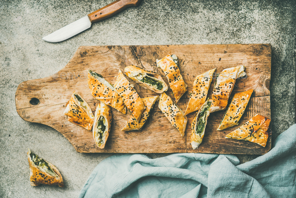 Freshly baked Turkish borek roll cut in slices, flat-lay - Stock Photo - Images