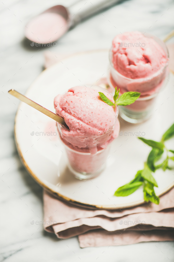 Homemade strawberry yogurt ice cream with mint on plate, vertical composition - Stock Photo - Images