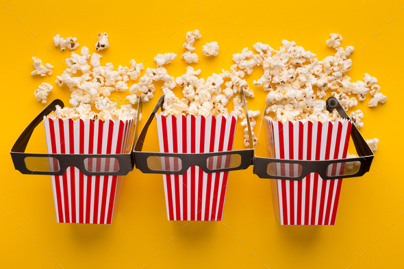 Buckets of popcorn on yellow background, top view - Stock Photo - Images