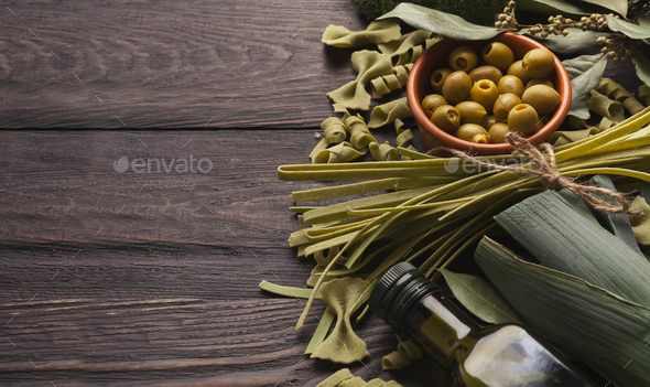 Assorted italian green pasta on wooden background - Stock Photo - Images