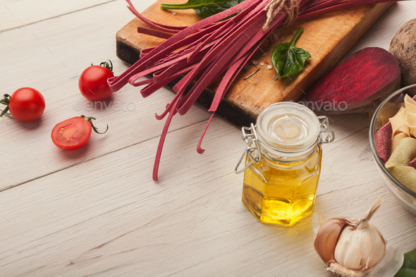 Colorful pasta and cooking ingredients on white wood - Stock Photo - Images