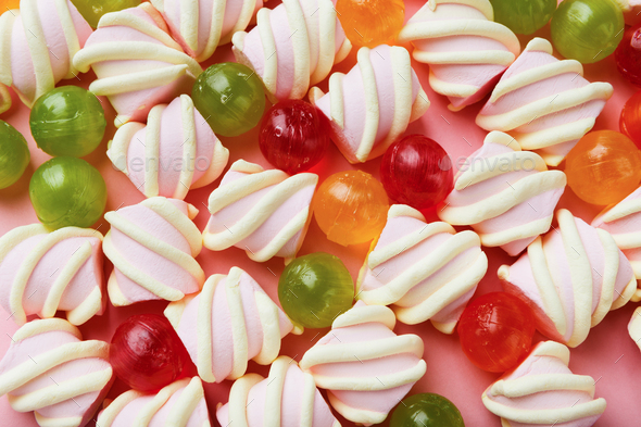Heap of marshmallows and colourful sweets on pink background - Stock Photo - Images