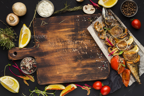 Grilled fish, cooking ingredients on wooden cutting board, top view - Stock Photo - Images
