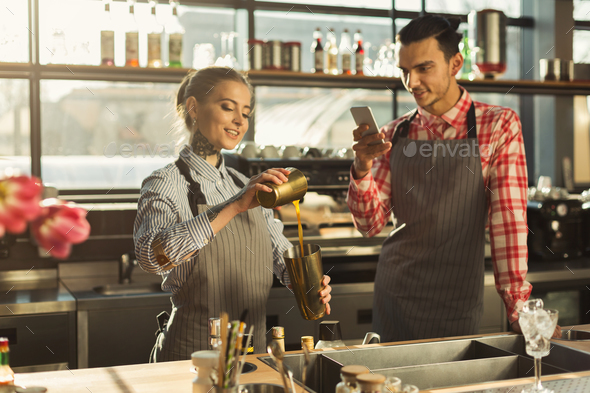 Male and female bartenders at coffee shop counter - Stock Photo - Images