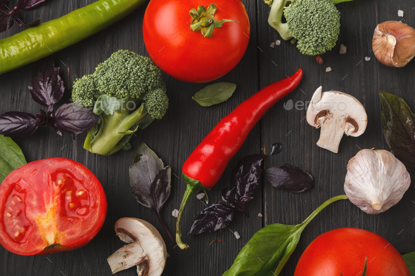 Fresh tomatoes and garlic closeup on dark rustic wood - Stock Photo - Images