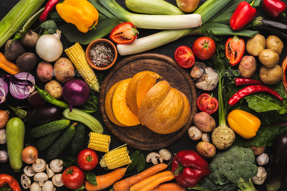 Fresh organic vegetables and wooden board background - Stock Photo - Images