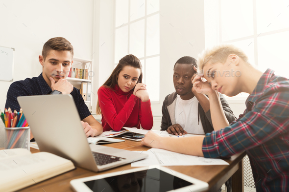 Multiethnic classmates preparing for exam together - Stock Photo - Images