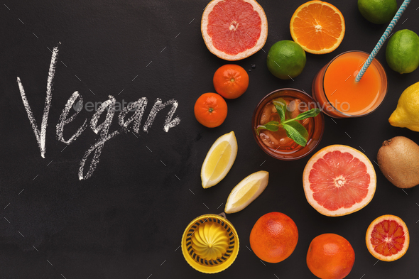 Various citrus fruits on black chalkboard background - Stock Photo - Images