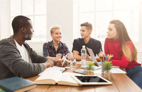 Multiethnic classmates preparing for exams together - Stock Photo - Images