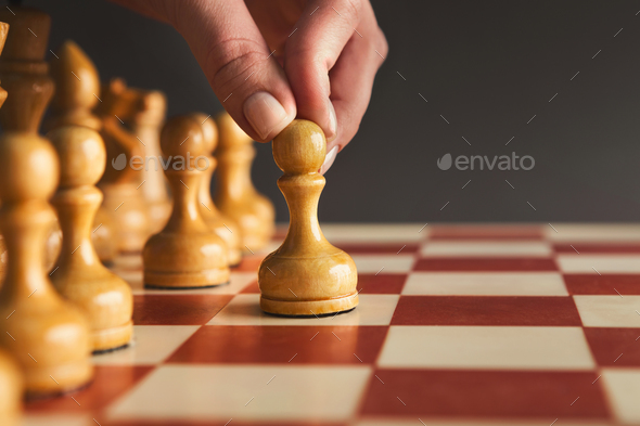 Hand of player chess board game putting white pawn - Stock Photo - Images