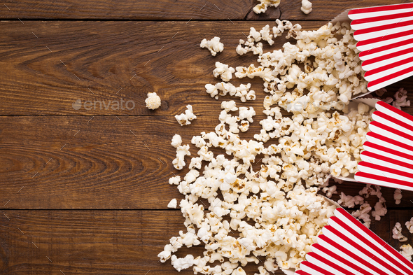 Bucket of popcorn on wooden background, top view - Stock Photo - Images