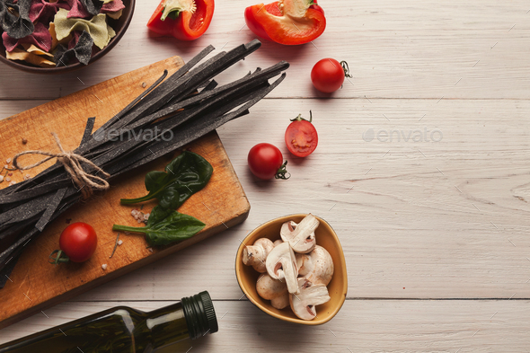 Colorful pasta and cooking ingredients on white wood - Stock Photo - Images