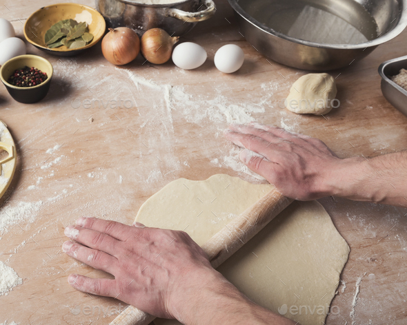 Preparing dumplings with meat, rolling out dough - Stock Photo - Images