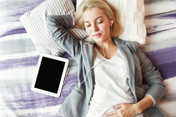 Top view of beautiful young woman lying on bed - Stock Photo - Images