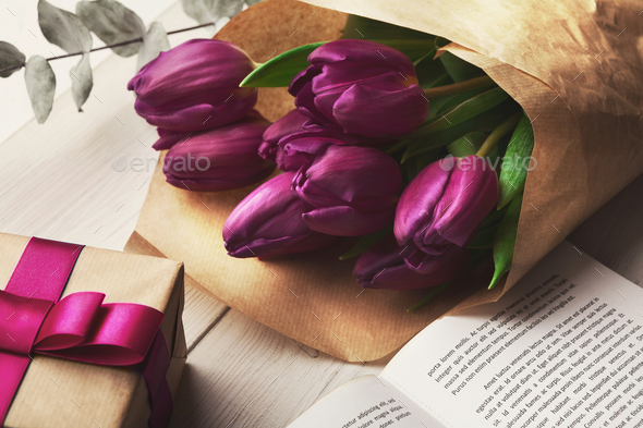 Bouqet of purple tulips and gift box on wooden background - Stock Photo - Images