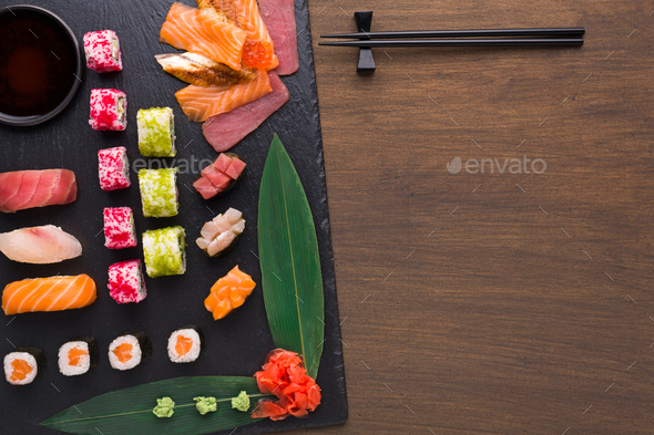 Set of assorted sushi, maki and rolls on rustic wooden background Stock Photo by Prostock-studio