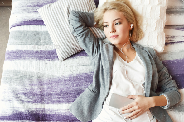 Top view of beautiful young woman lying on bed - Stock Photo - Images