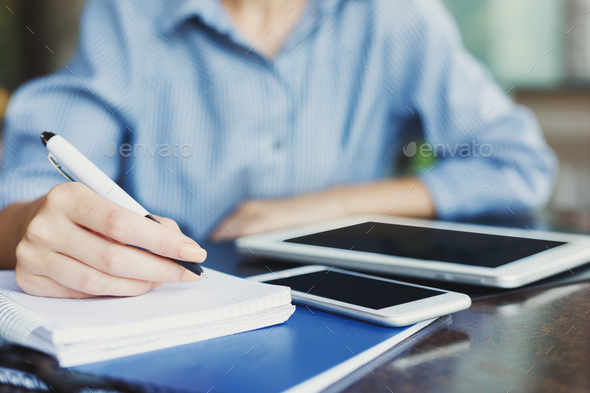 Female hand writing notes closeup outdoors - Stock Photo - Images