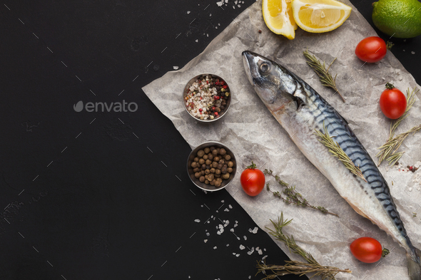 Mackerel and cooking ingredients on black background - Stock Photo - Images