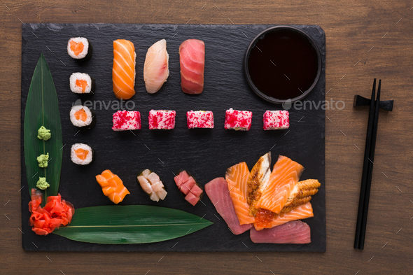 Set of assorted sushi, maki and rolls on rustic wooden background - Stock Photo - Images
