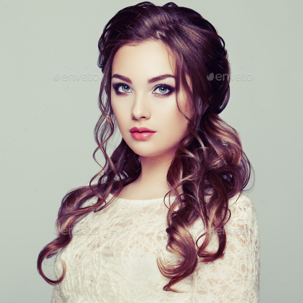 Brunette woman with long and shiny curly hair Stock Photo by heckmannoleg