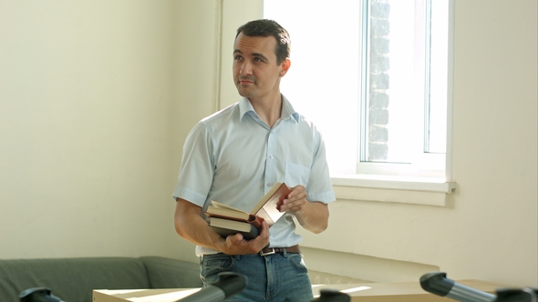 Smiling Student in the Library Studying and Day Dreaming, He Is Thinking and Looking Up alt