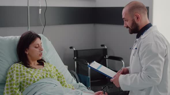 Practitioner Physician Writing Test Expertise on Clipboard Monitoring Disease Diagnose alt