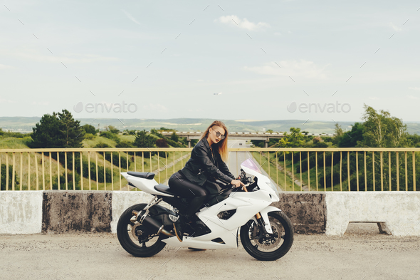 Beautiful woman with sunglasses driving on motorbike - Stock Photo - Images