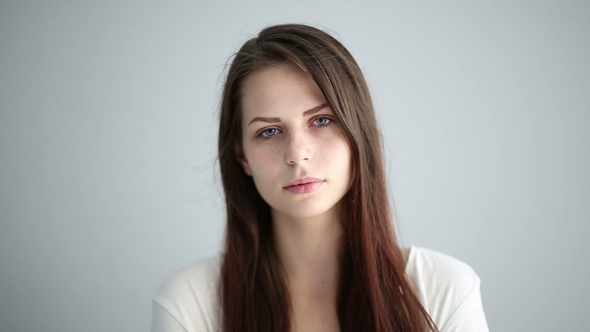 Portrait of a Beautiful Girl in the Studio on a Gray Background alt