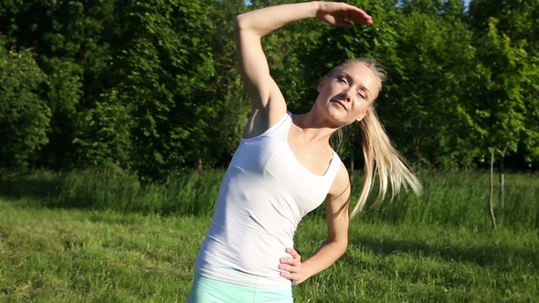 Beautiful Blonde Woman Engaged in Fitness in the Park