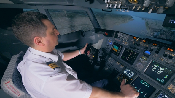 Demonstration Flight Is Being Performed By a Male Instructor in a Flight Simulator alt