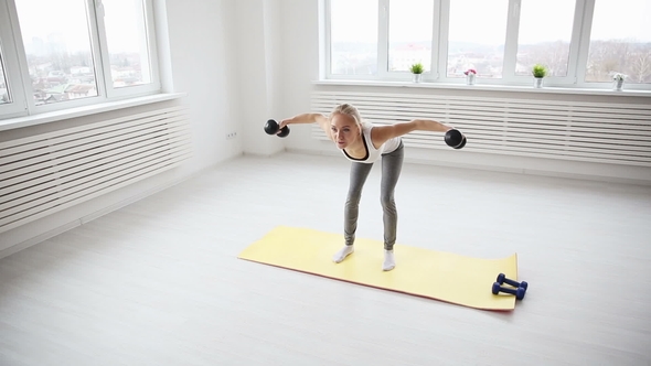 A Sporty European-looking Girl Doing Pilates