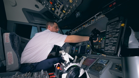 Flight Instructor Is Checking Readiness of the Equipment in the Flight Simulator Before Launching alt