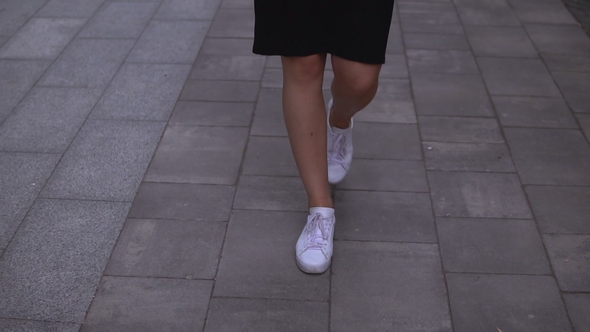 Businesswoman Walks on the Street alt