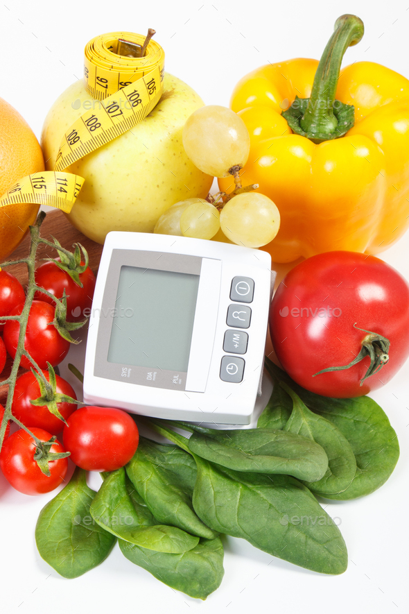 Blood pressure monitor, fruits with vegetables and centimeter, prevention of hypertension concept - Stock Photo - Images