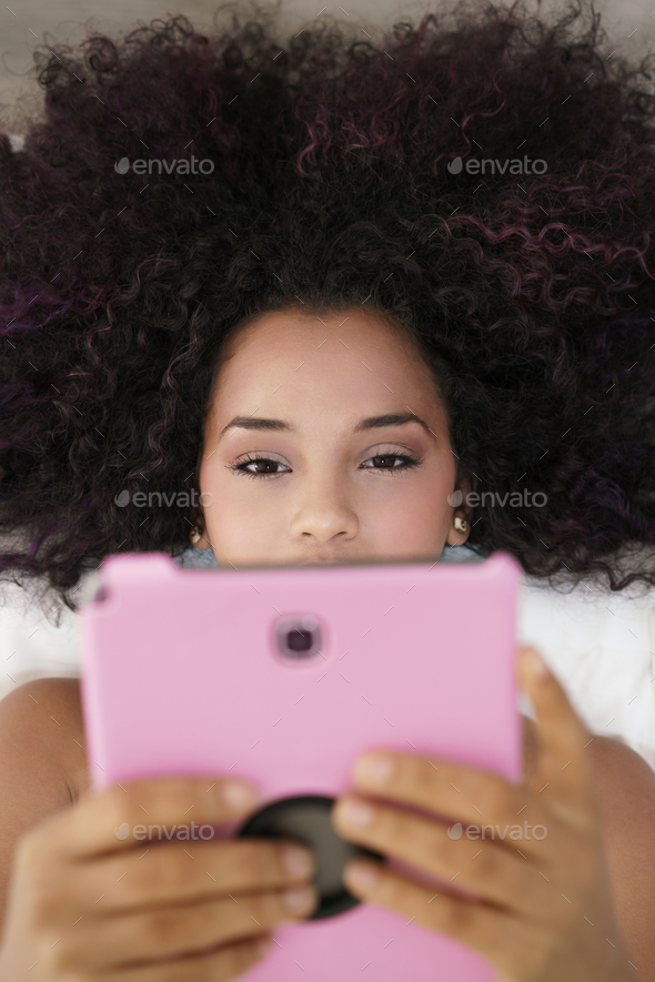 Hispanic Girl Using Digital Tablet For School Homework - Stock Photo - Images