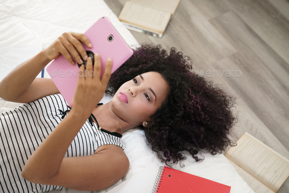 Hispanic Girl Using Digital Tablet For School Homework - Stock Photo - Images